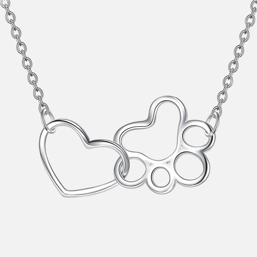 Silver paw print pendant necklace with heart outline and small crystal accents