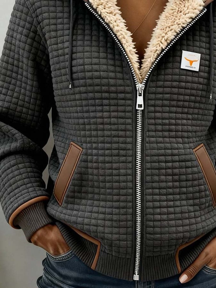 Sherpa-lined quilted hooded jacket with front zip, side pockets, and tan leather-like accents